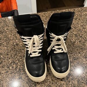 Gently used pair of black and cream high top men’s luxury sneakers in size 46.